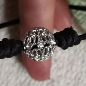 Silvertone Crystal Ball on black silk cord bracelet